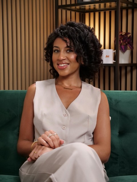 Host seated on the studio sofa during a recording